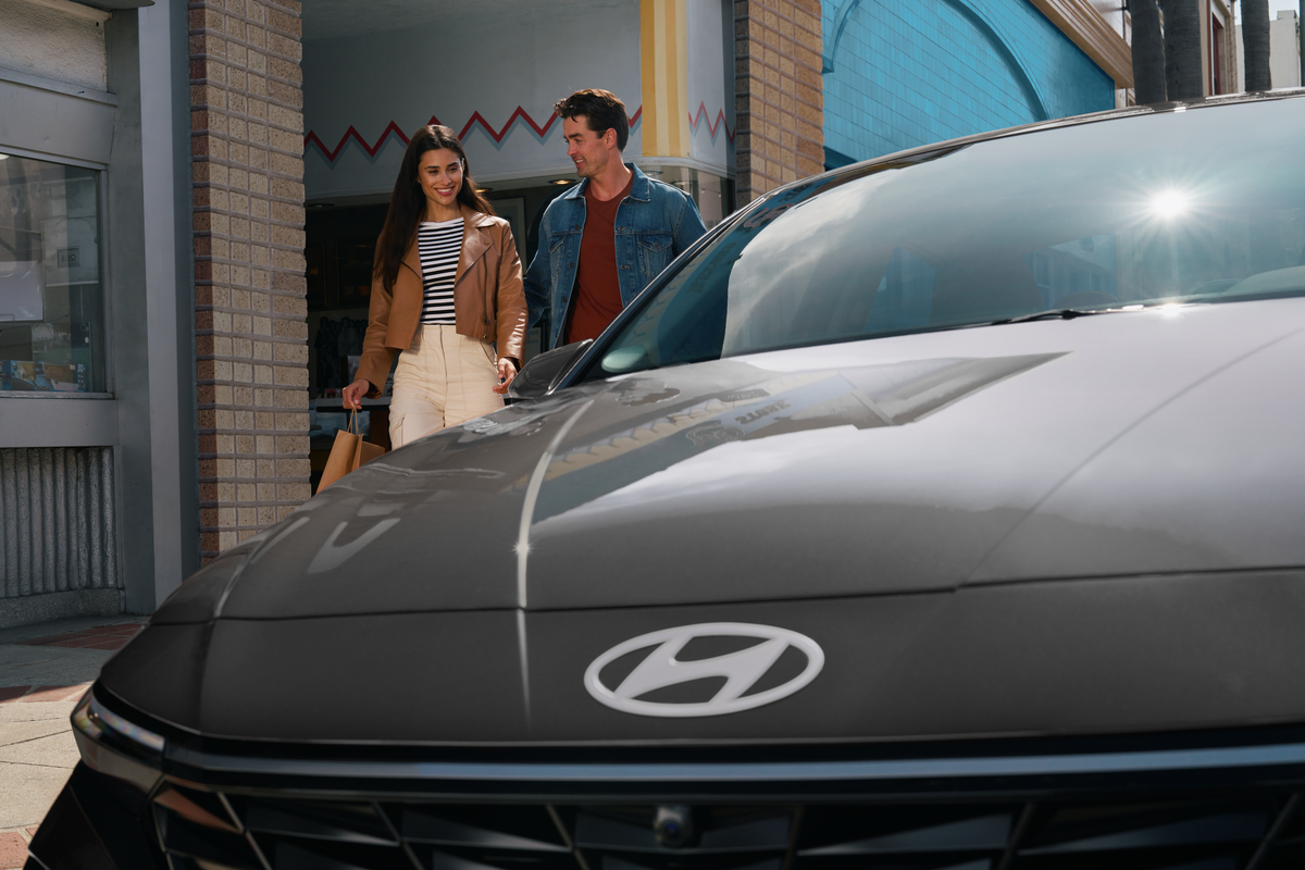 couple walking to their hyundai vehicle